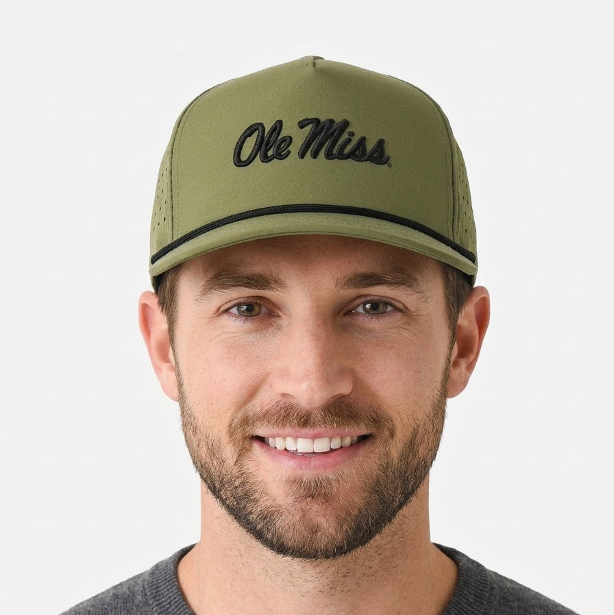 Man wearing a green 'Ole Miss' cap against a white background