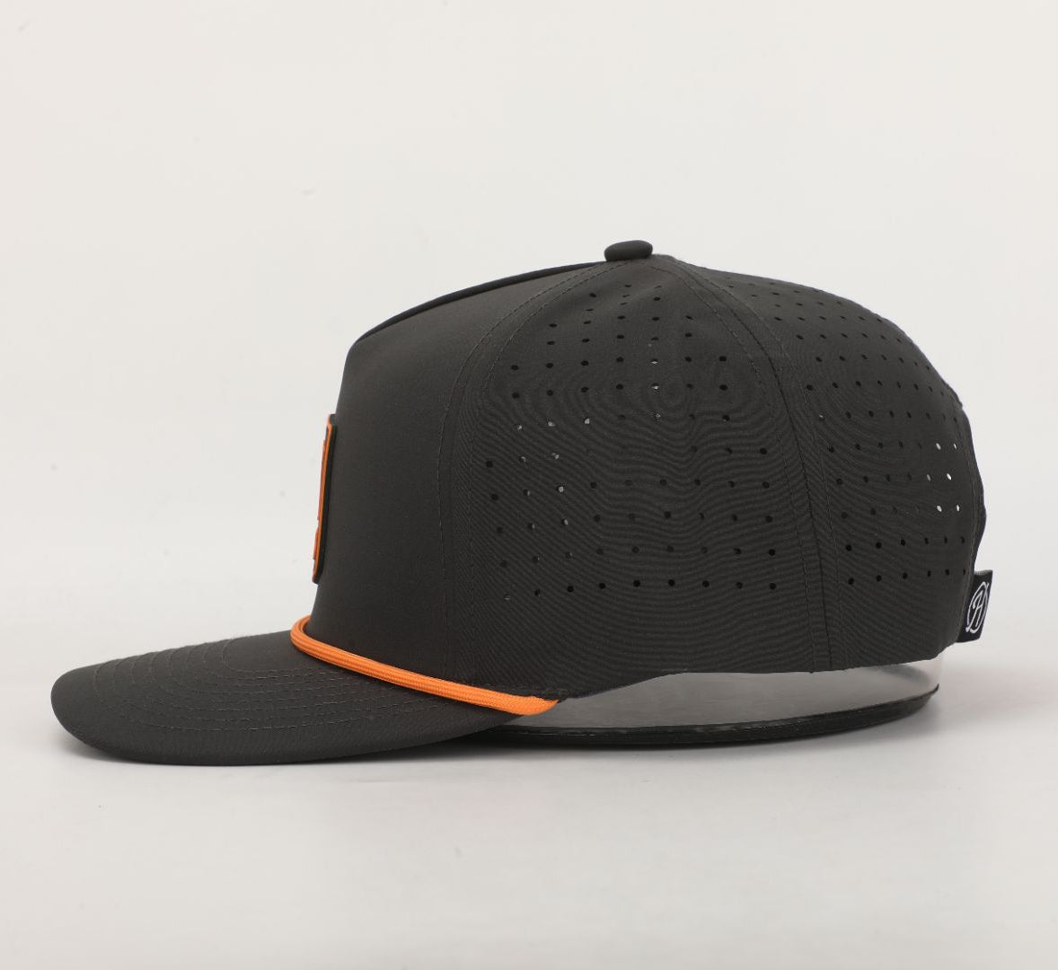 Black cap with orange accents on a light gray background