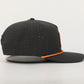 Black cap with orange accents on a light gray background