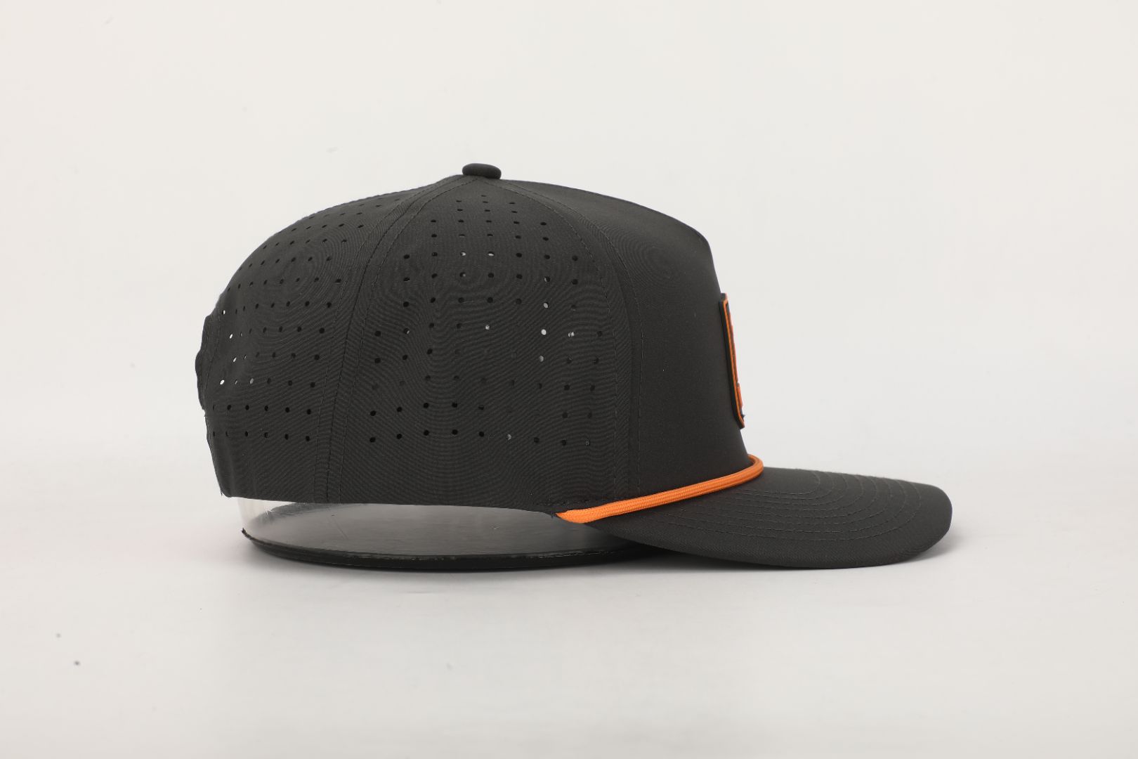 Black cap with orange accents on a light gray background