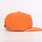 Orange cap with a white logo on a light gray background