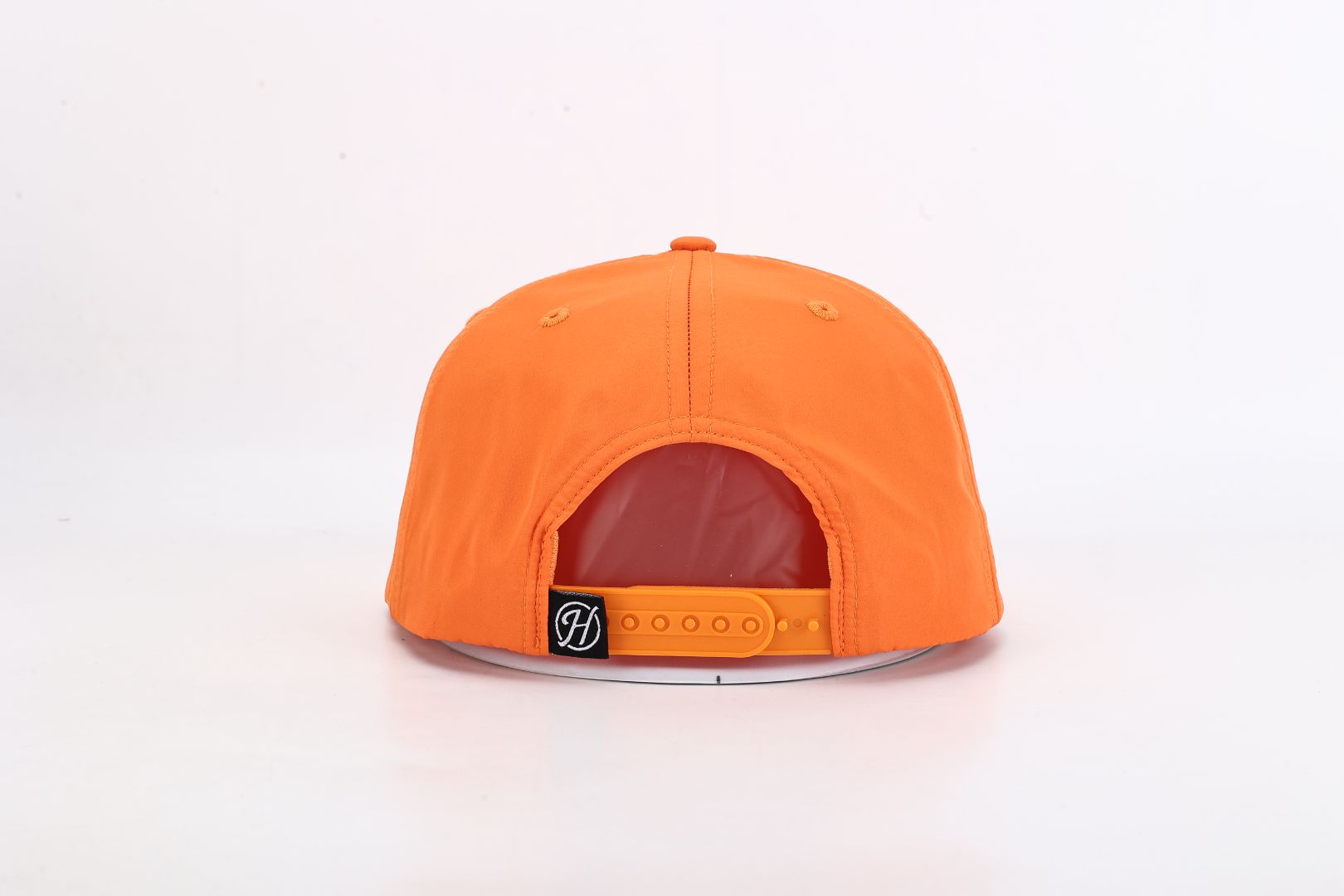 Orange cap with a visible brand logo on a white background