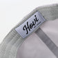 Gray cap with a visible brand label on a light gray background