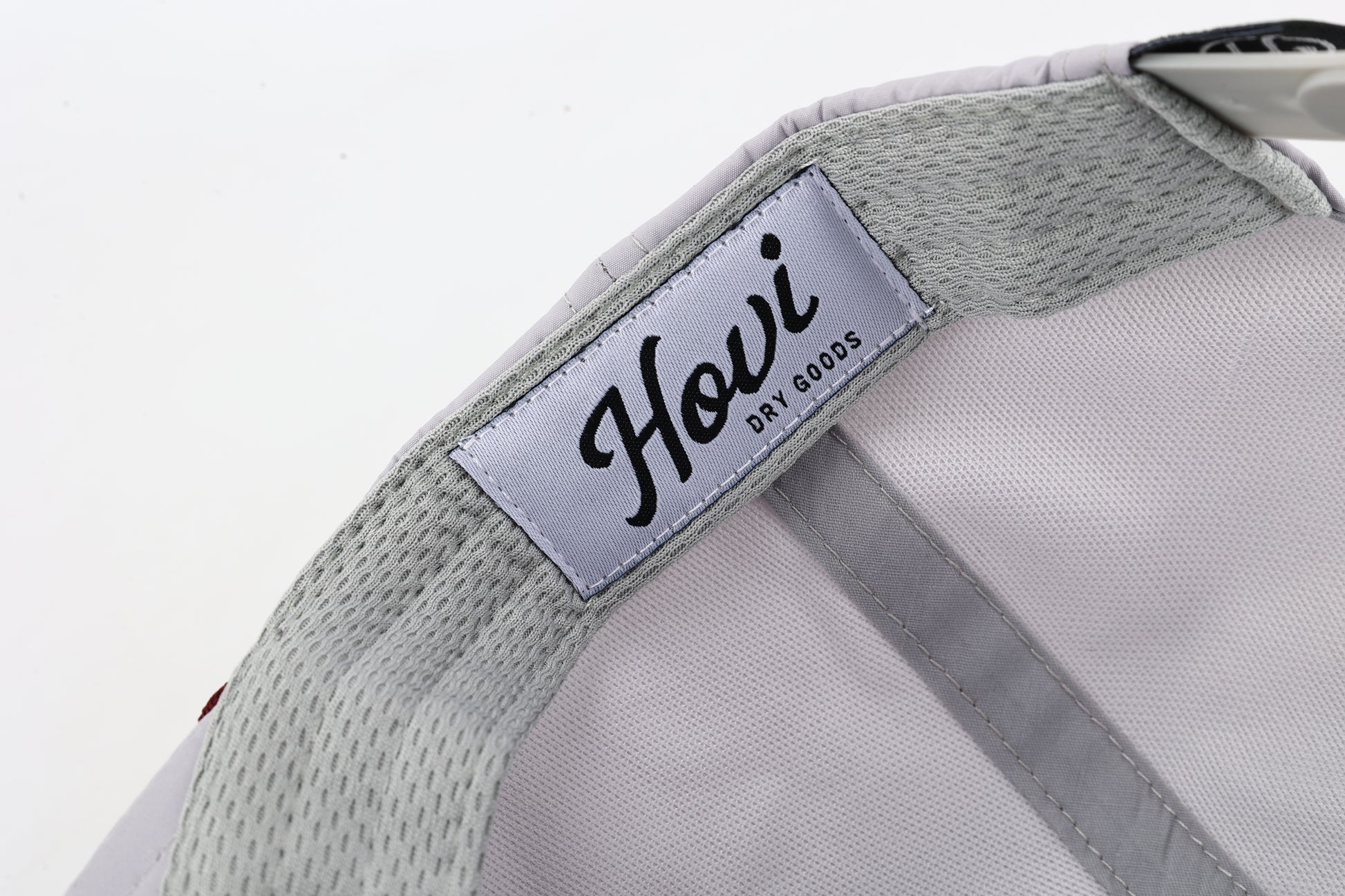 Gray cap with a visible brand label on a light gray background