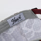 Close-up of a dog collar with 'Howi' brand label on a white background