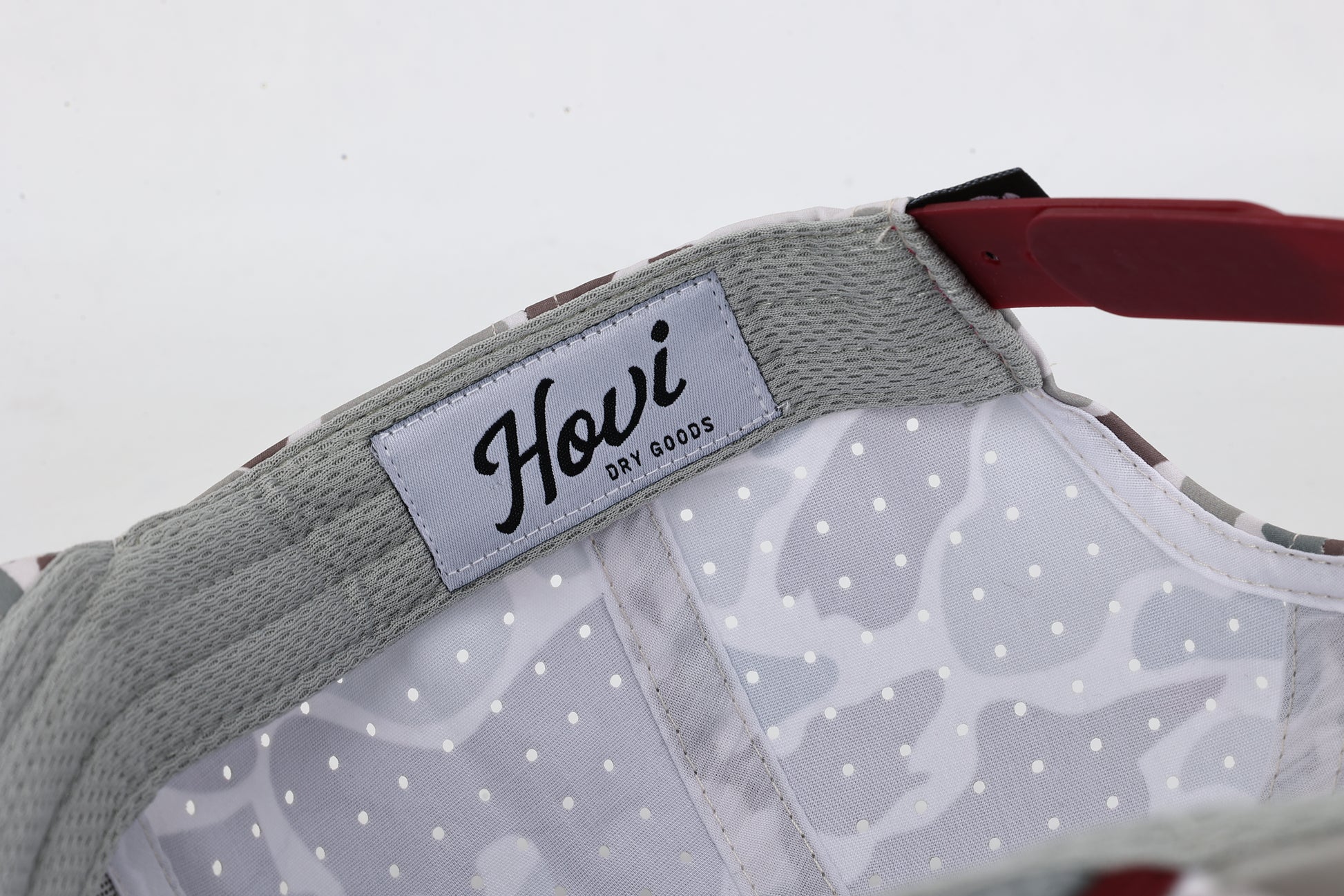 Close-up of a dog collar with 'Howi' brand label on a white background