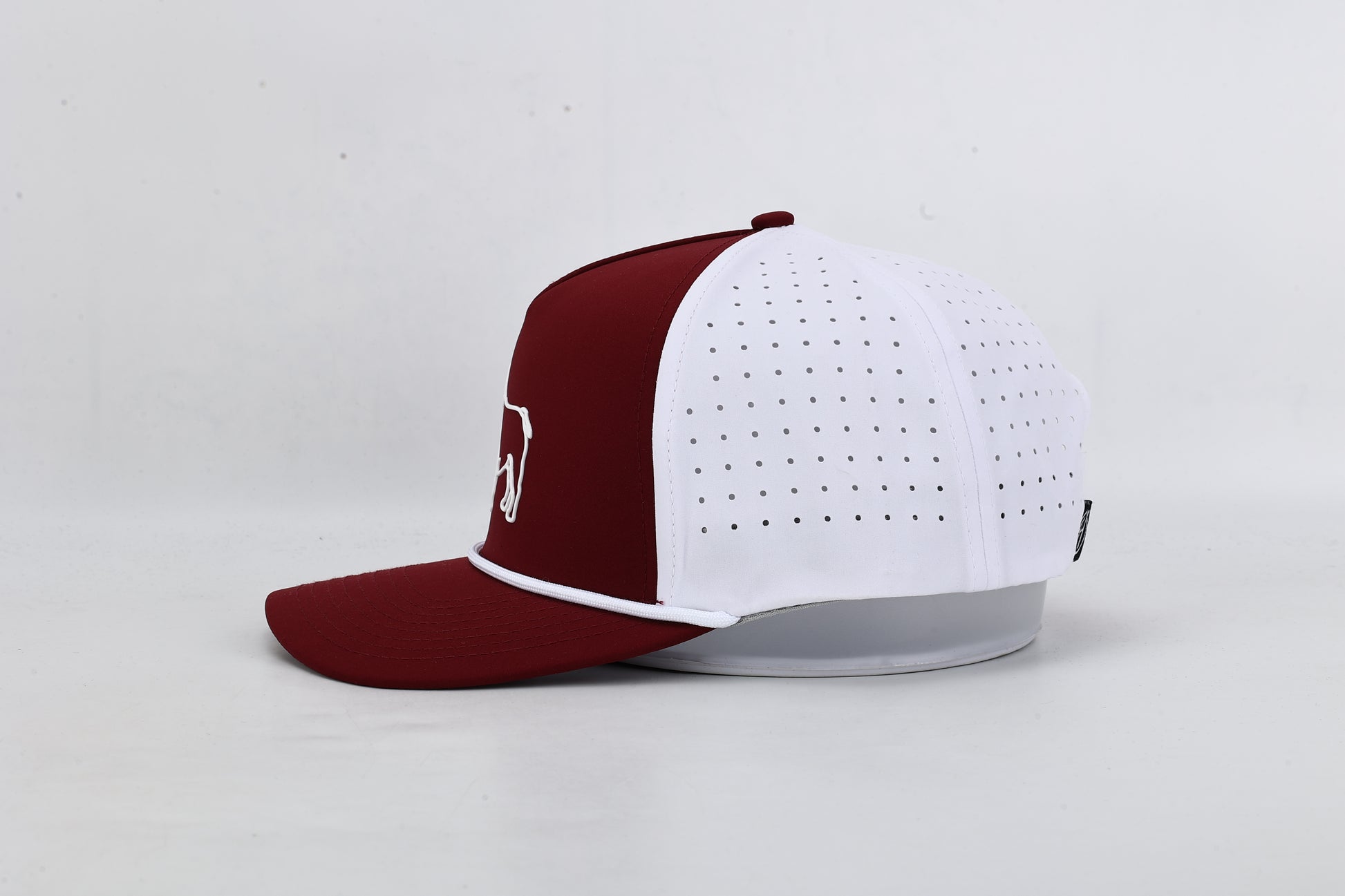 Maroon and white baseball cap with a logo on a light gray background
